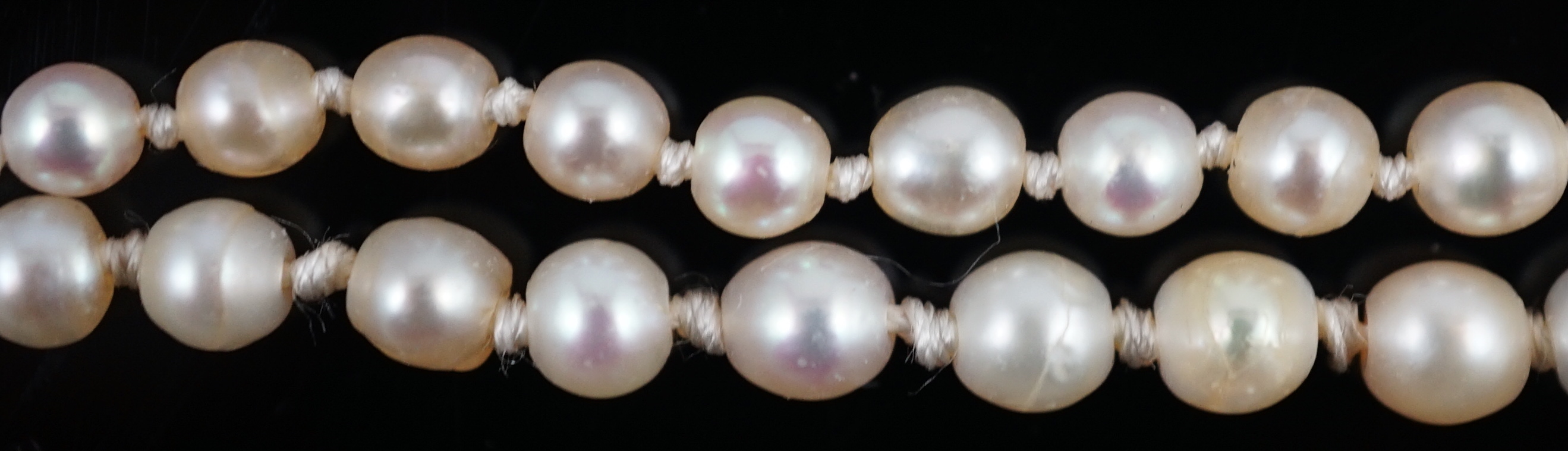 A twin strand graduated cultured pearl necklace, with gold and six stone diamond set rectangular clasp